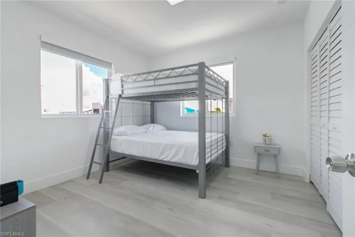 Bedroom featuring light wood-type flooring and multiple windows
