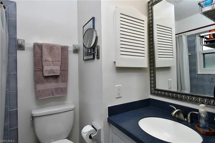 Bathroom with walk in shower, vanity, and toilet