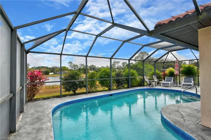 View of pool with a lanai and a patio area