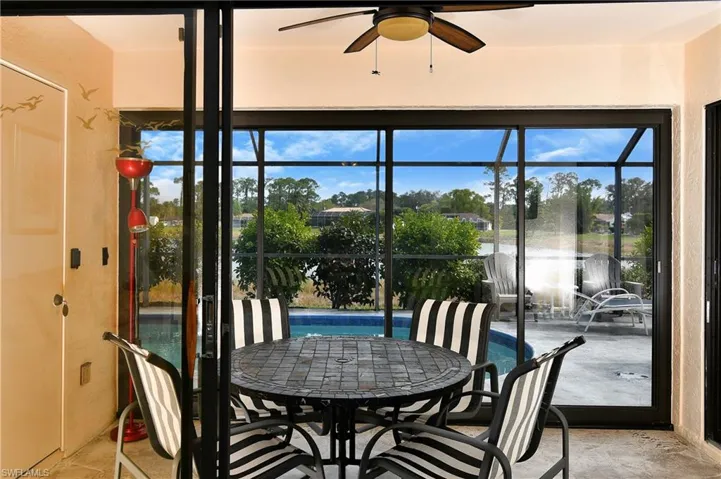 Sunroom featuring a water view, ceiling fan, and a healthy amount of sunlight
