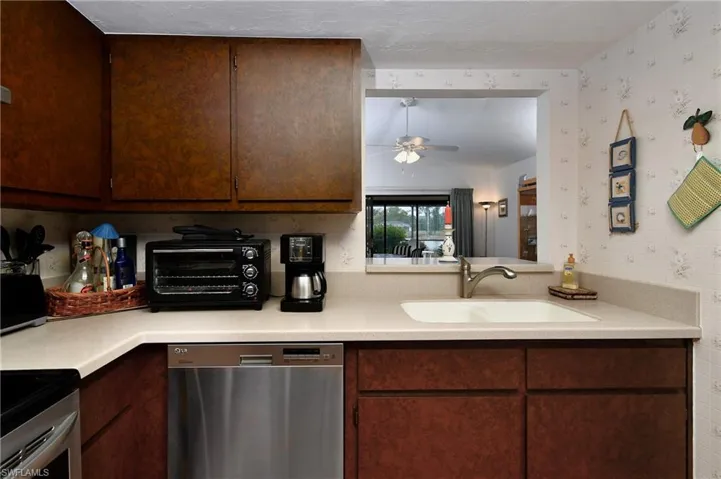 Kitchen with sink, ceiling fan, dishwasher, and range