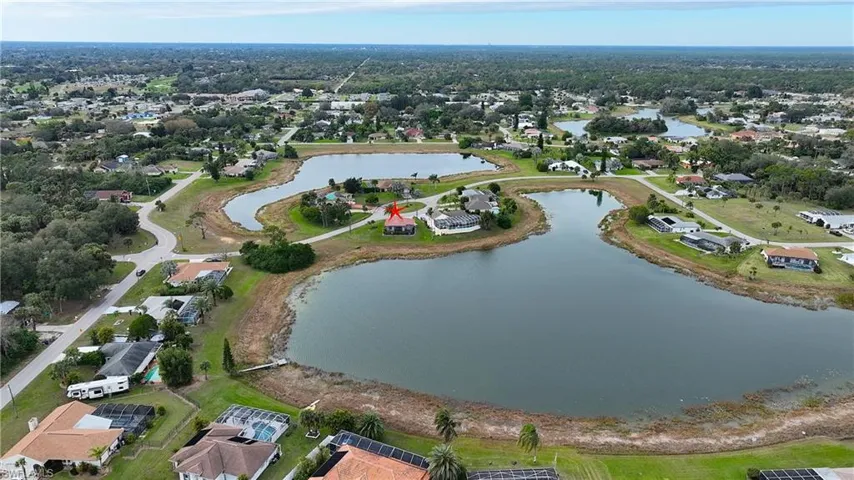 Birds eye view of property with a water view