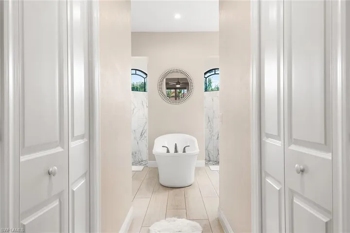 Owners bathroom featuring and shower with separate bathtub