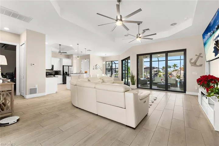 Living room with plentiful natural light and tray ceiling