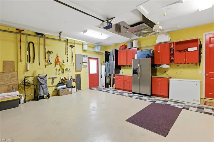 Organized bliss! Granite countertops, custom cabinetry, extra fridge/freezer, chest freezer, and wall-to-wall storage for ultimate functionality.