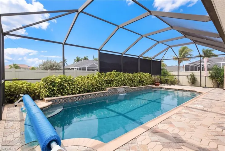 A resort-style backyard—lanai, pool, and privacy all in one stunning space.