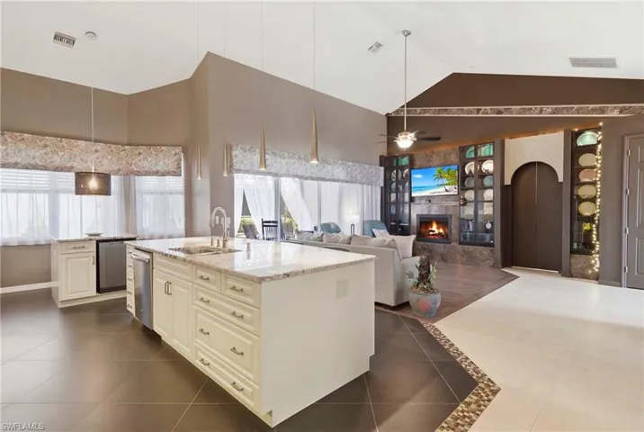 From cooking to relaxing—custom kitchen, open living room, and a wine cooler for your favorite vintages.
