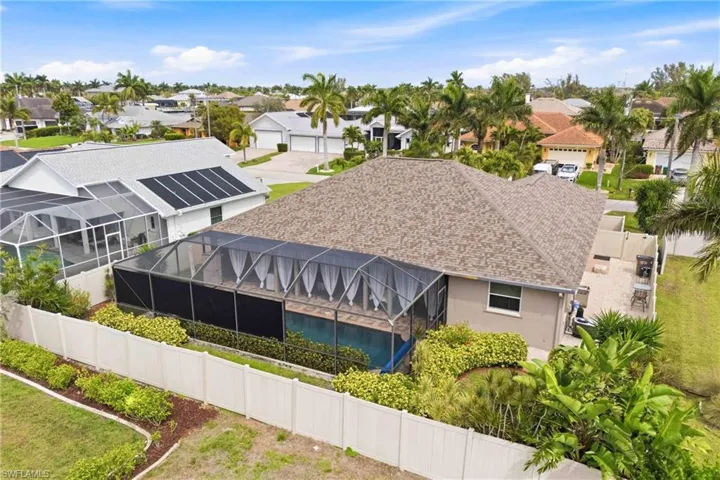 From the sky, your Florida getaway truly shines—pool, screened lanai, and lush landscaping make a picture-perfect scene.