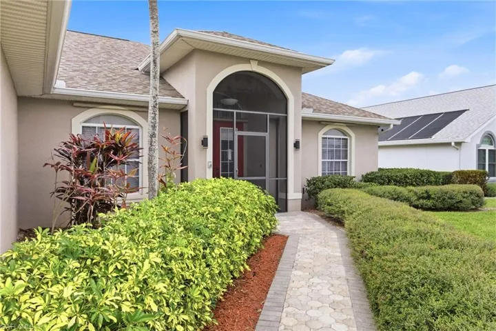 Your dream home begins at the front door—flawless exterior and tropical flair.