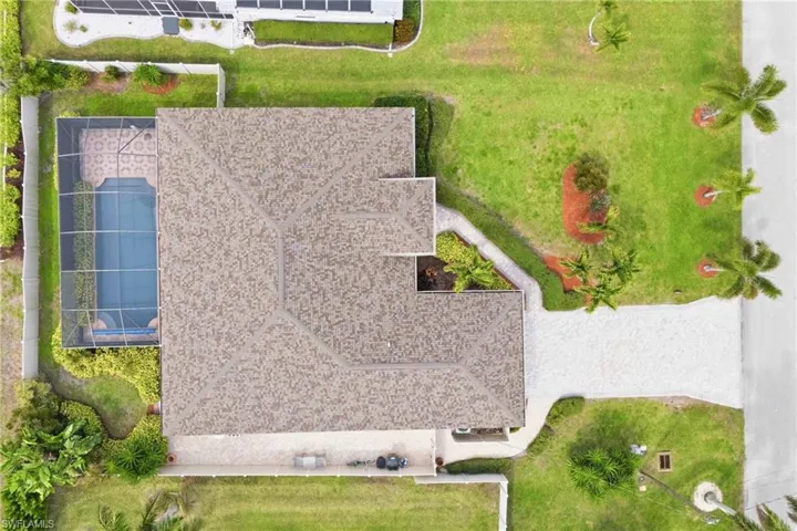 Breathtaking views of your private tropical oasis—soaring above the lush landscaping, sparkling heated pool, and screened lanai. The ultimate Florida paradise awaits!