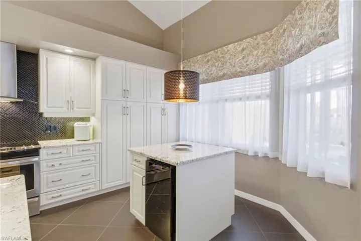Seamless flow from kitchen to living area with every detail in place, including a stylish wine cooler.