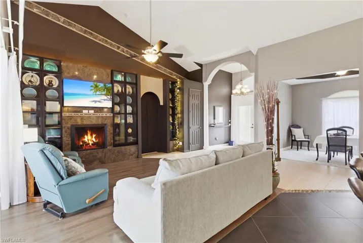 A show-stopping living area with built-in shelving, fireplace, and soaring ceilings!