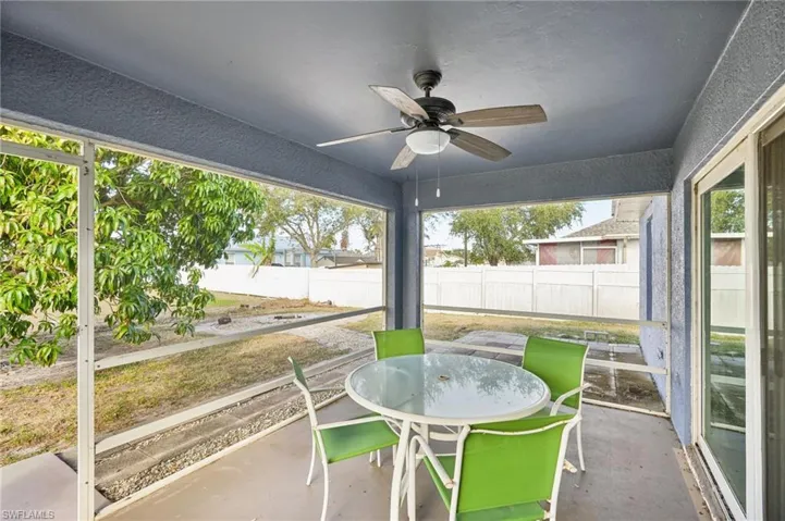Unfurnished sunroom with ceiling fan