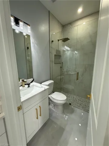 Full bathroom featuring vanity and a stall shower