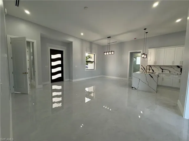 Unfurnished dining area featuring recessed lighting and light marble finish flooring