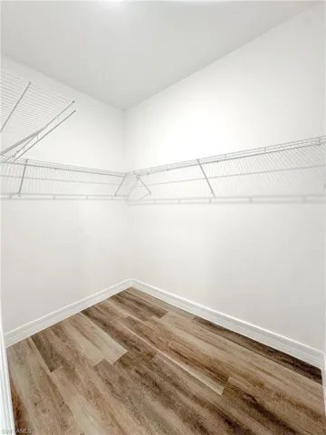 Walk in closet featuring hardwood / wood-style flooring