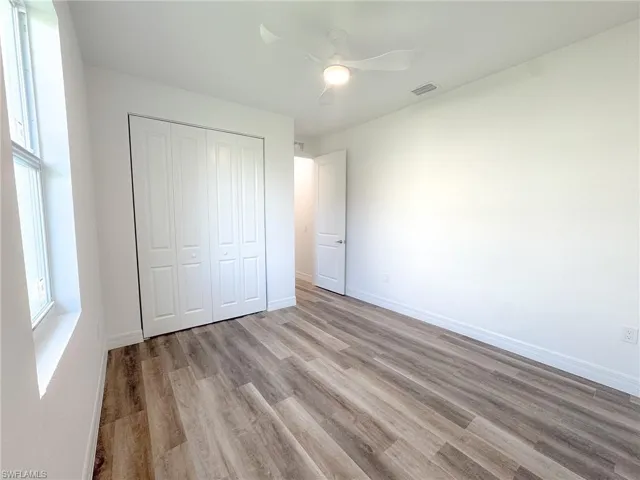 Bedroom #2 Unfurnished bedroom featuring a closet, light hardwood / wood-style floors, and ceiling fan
