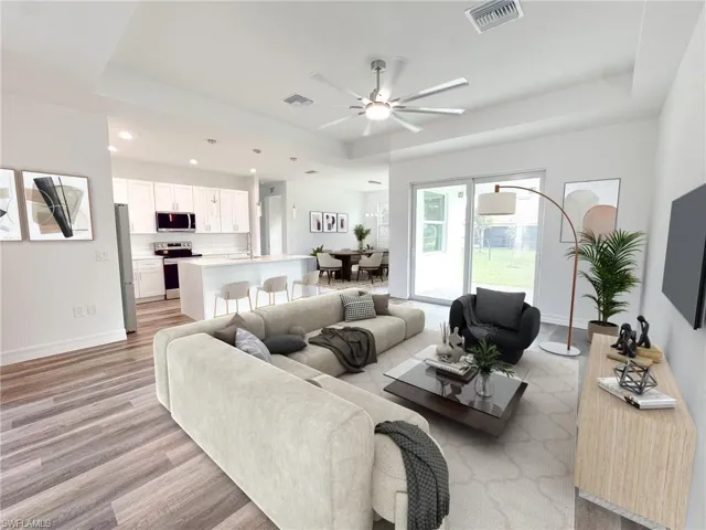 Deco Render - Furnished Living room featuring sink, a tray ceiling, light wood-type flooring, and ceiling fan