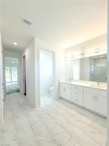 Master Bathroom with toilet, walk in shower, and 2 vanity