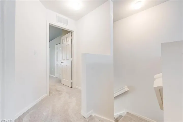 Stairway and hallway to primary bedroom