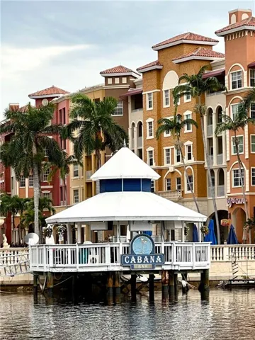 Back of property with a water view and a gazebo