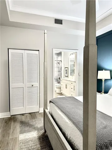 Bedroom with light wood-style flooring and a closet