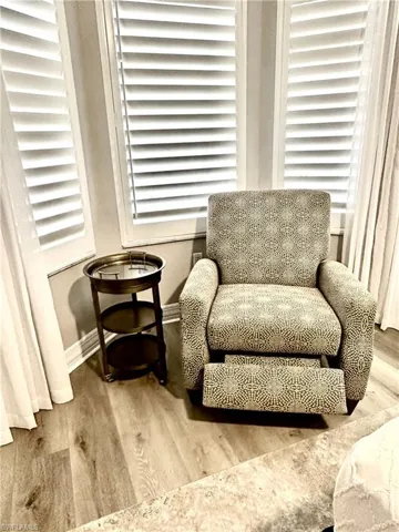 Living area with wood finished floors and baseboards