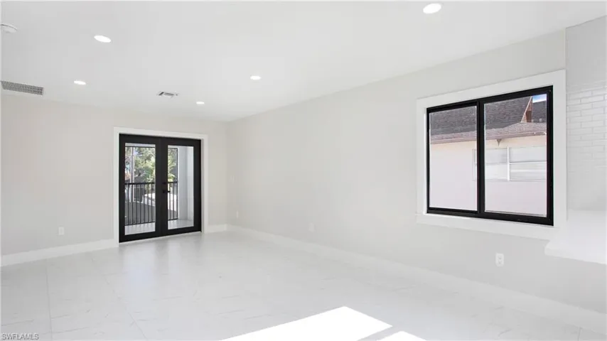 Empty room featuring recessed lighting and french doors