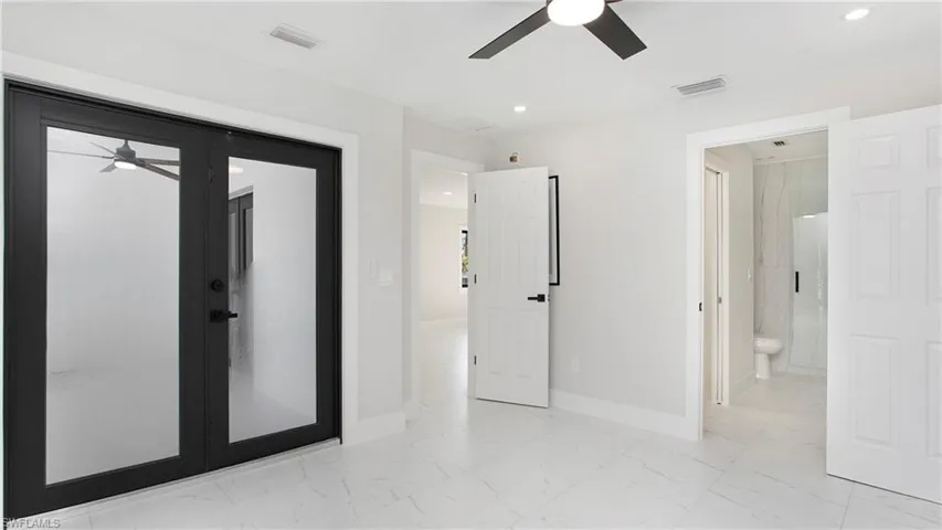 Unfurnished bedroom with light marble finish floors, ceiling fan, and recessed lighting