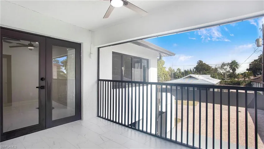 Balcony with a ceiling fan and french doors