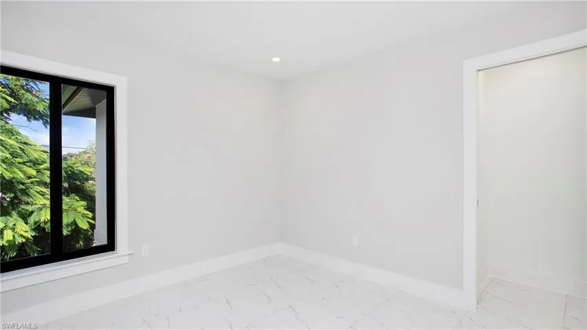 Unfurnished room with light marble finish floors and recessed lighting