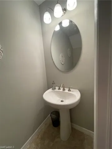 Bathroom with tile patterned floors and baseboards
