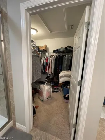 Spacious closet featuring carpet and visible vents