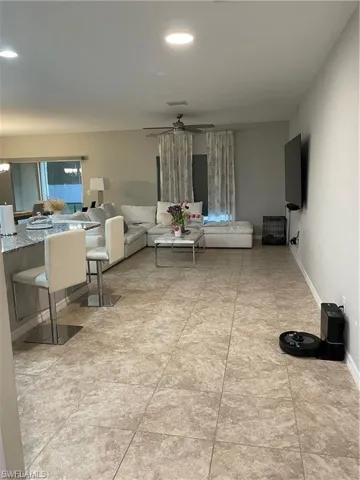 Living room with recessed lighting, a ceiling fan, and baseboards