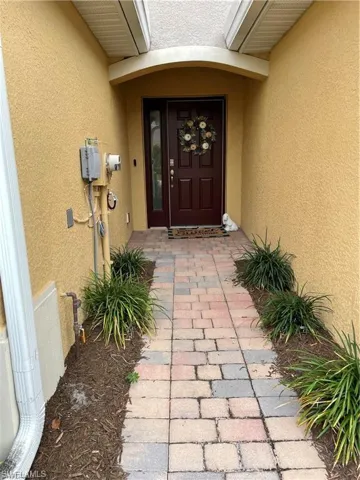 Doorway to property with stucco siding