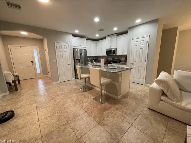 Kitchen featuring recessed lighting, visible vents, white cabinetry, appliances with stainless steel finishes, and open floor plan