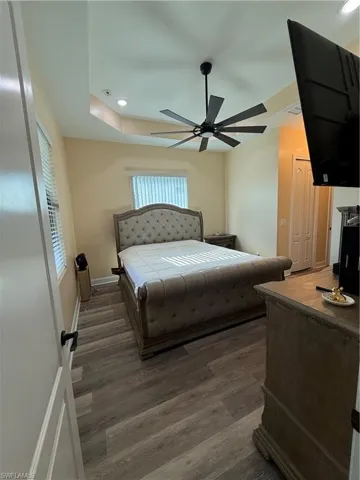 Bedroom with a closet, a ceiling fan, recessed lighting, and wood finished floors