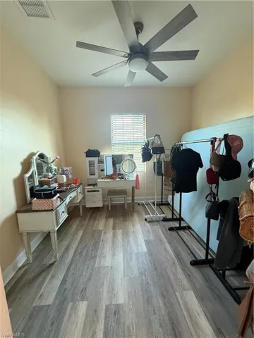 Workout room featuring light wood-style flooring and ceiling fan