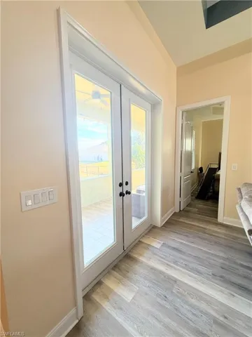 Entryway with french doors and wood finished floors