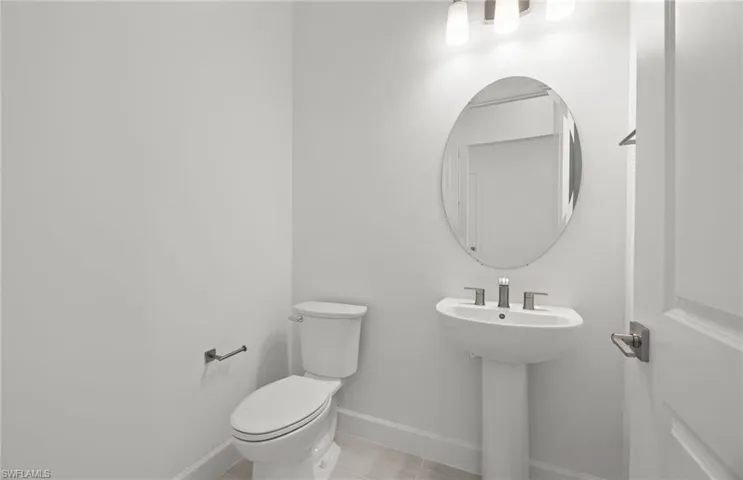 Bathroom featuring tile floors and toilet