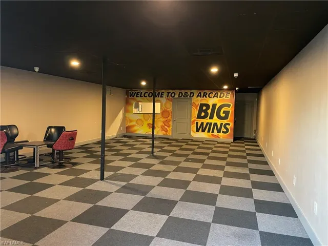 Basement featuring dark colored carpet