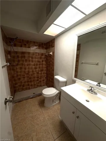 Bathroom featuring a stall shower and vanity
