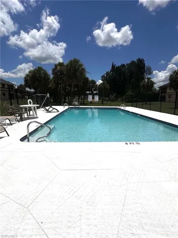 Community pool featuring a patio