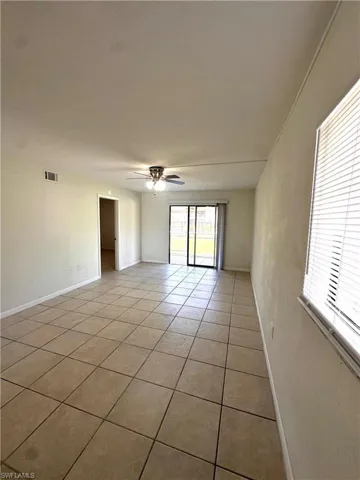Spare room with light tile patterned floors and a ceiling fan