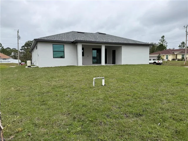 Rear view of house with a lawn