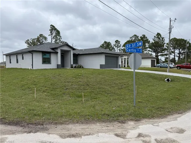 View of front facade with a front yard and a garage