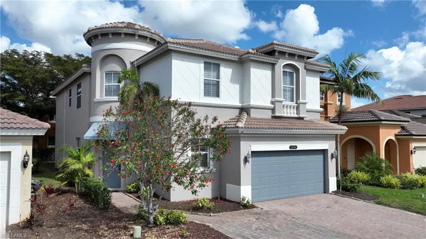 Mediterranean / spanish home with a garage