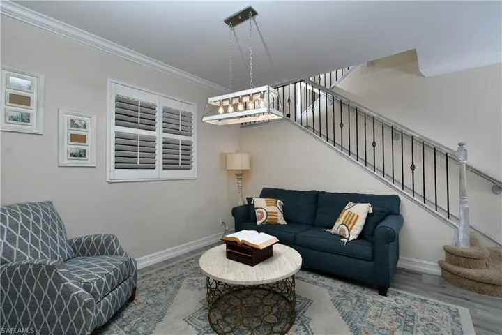 Living room featuring hardwood / wood-style flooring and ornamental molding