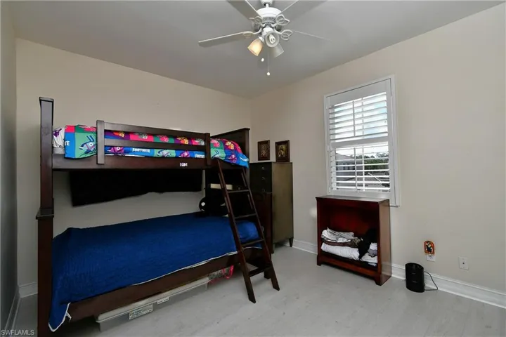 Bedroom with ceiling fan and wood-type flooring