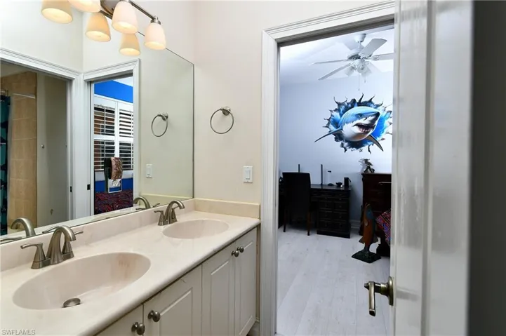 Bathroom featuring vanity, hardwood / wood-style floors, and ceiling fan